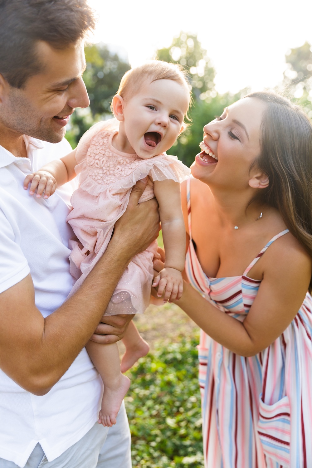 Happy young family with little baby girl spending time together